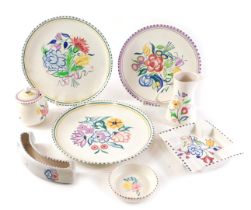 A group of Poole pottery, comprising two large plates, a medium plate, ashtray, mustard and cover, j