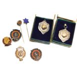 A group of enamel badges and tie pins, comprising two crests for The Strength League, enamel decorat