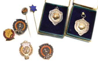 A group of enamel badges and tie pins, comprising two crests for The Strength League, enamel decorat