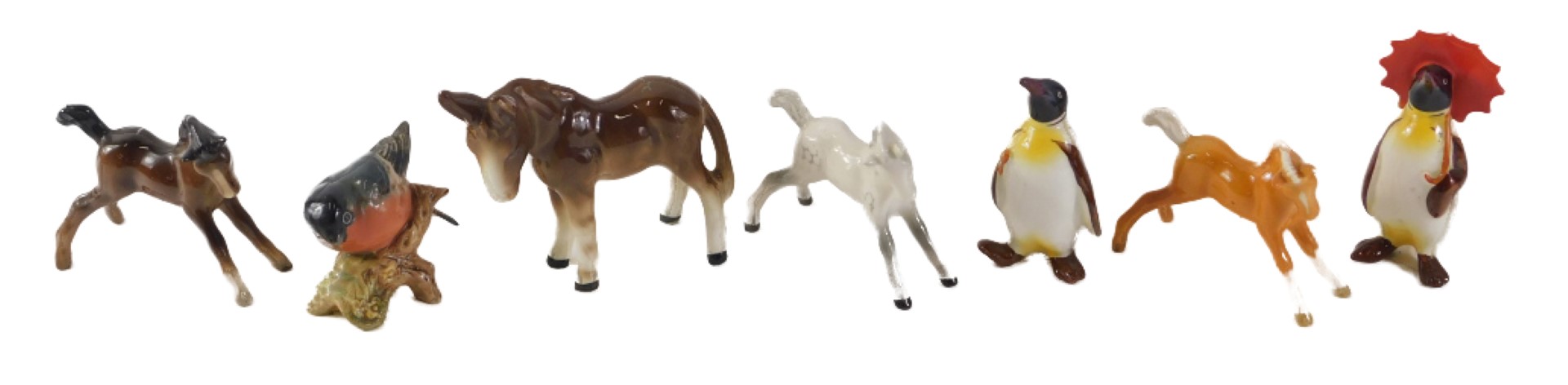 Beswick ornaments, comprising a Beswick donkey, three foals, and a finch, the largest 9cm high, and