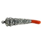A Victorian teething rattle, with a coral base, with embossed floral top, white metal unmarked, 11cm