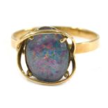 An imitation opal dress ring, the imitation opal doublet, with dark blue flare, in a raised yellow m