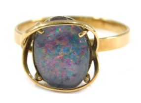 An imitation opal dress ring, the imitation opal doublet, with dark blue flare, in a raised yellow m