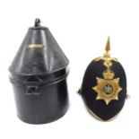 A Victorian Manchester regimental helmet, with a gilt metal spike, in tin travelling case, with vaca