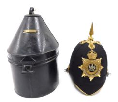 A Victorian Manchester regimental helmet, with a gilt metal spike, in tin travelling case, with vaca