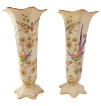 A pair of Crown Ducal stem vases, each with a petalated top and a painted decoration of flowers and