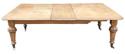 A Victorian oak extending dining table, the rectangular top with a moulded edge, on turned and flute