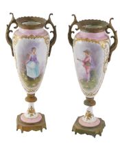 A pair of Continental porcelain and ormolu urns, each on a pink and white ground depicting transfer