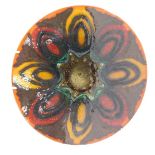 A Poole Delphis charger, decorated with ovals in shades of orange, green, yellow, etc., 27cm diamete