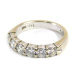 A diamond half hoop dress ring, set with six round brilliant cut diamonds, measuring between 3.35mm