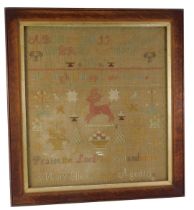 A 19thC sampler by Mary Ellen Clark aged 10, embroidered with stag, alphabet, etc., in oak frame, 53