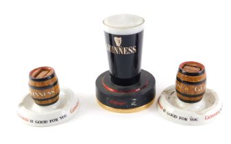 A Mintons Guinness match striker, another similar, and a Guinness lamp. (3)
