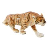 A Royal Dux figure of a prowling tiger, stamped to underside, 30cm wide.