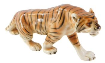 A Royal Dux figure of a prowling tiger, stamped to underside, 30cm wide.