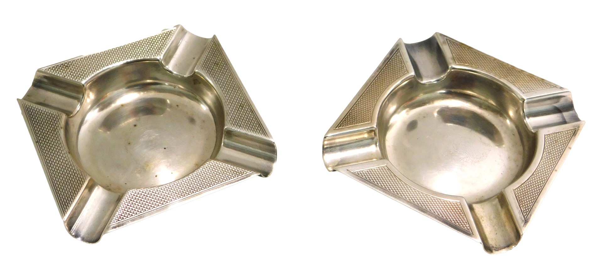 A matched pair of George V silver ashtrays, each of square form, with engine turned border, Birmingh