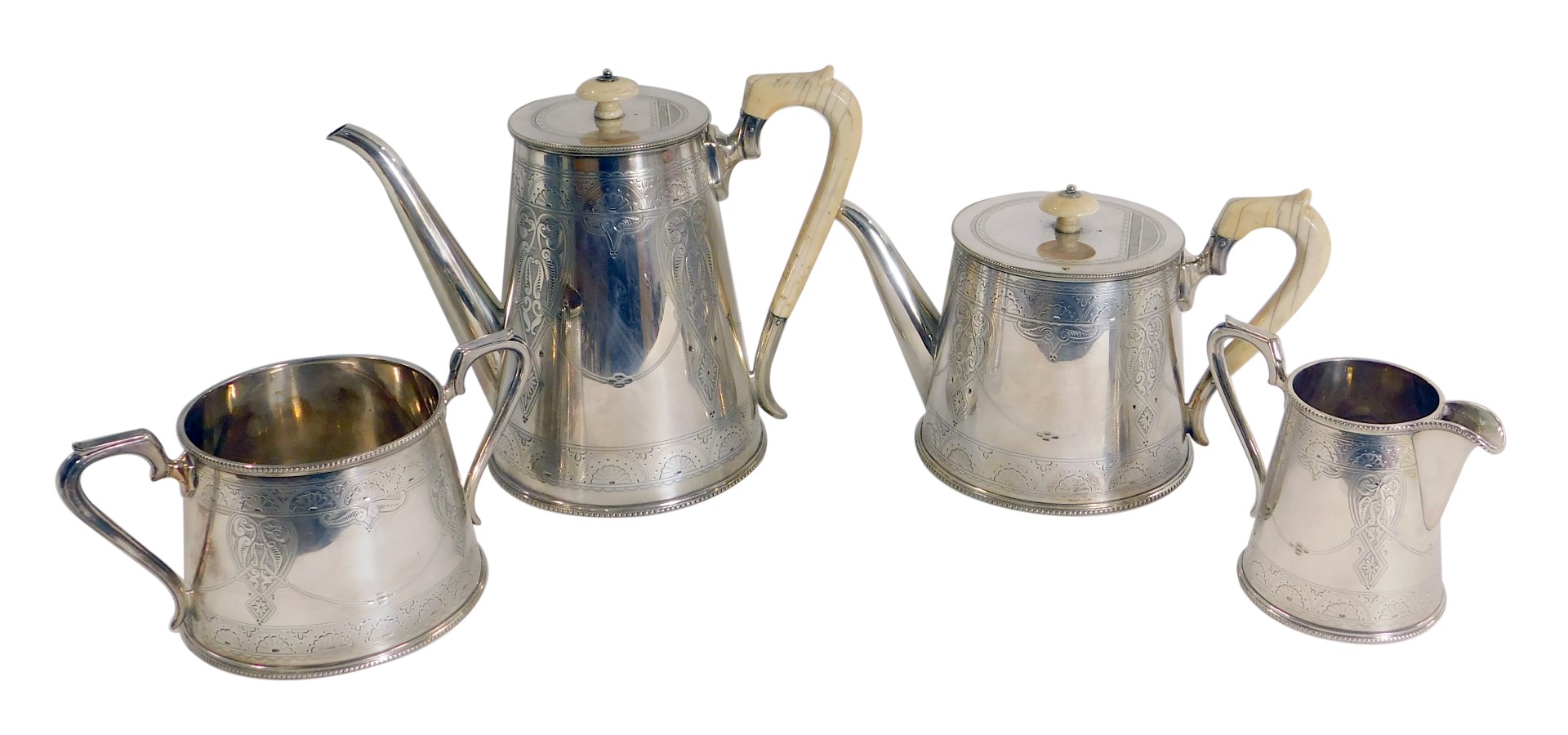 An early 20thC silver plated four piece tea and coffee service, with bright cut fan and scroll detai