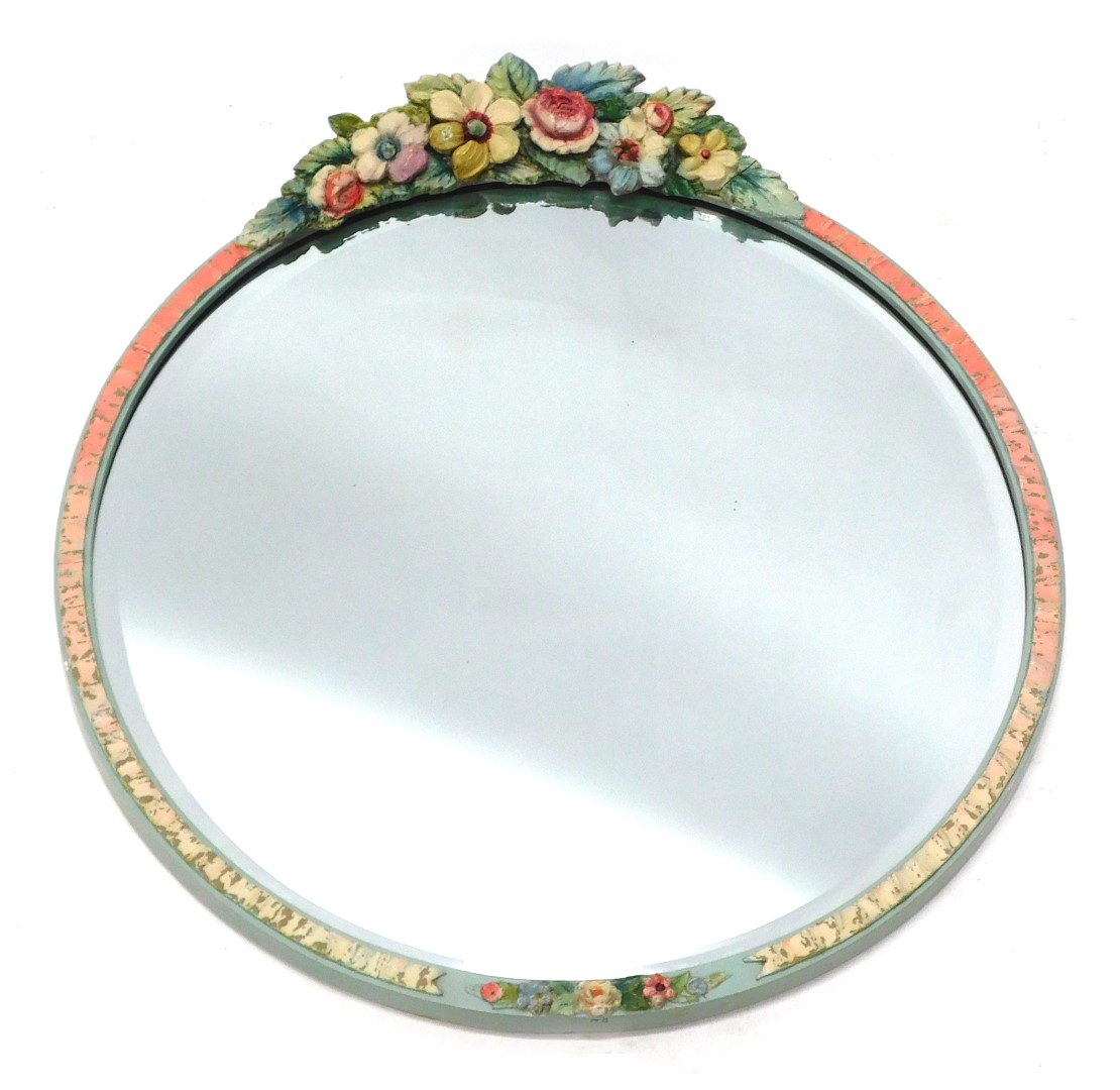 A Barbola 1950s circular wall mirror, with a blue and pink painted border, with raised flower crest,