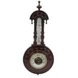 An early 20thC carved mahogany cased aneroid barometer, with opaque glass thermometer, 51cm high.