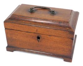 A George III mahogany tea caddy, the canted hinged lid with a brass handle enclosing vacant interior