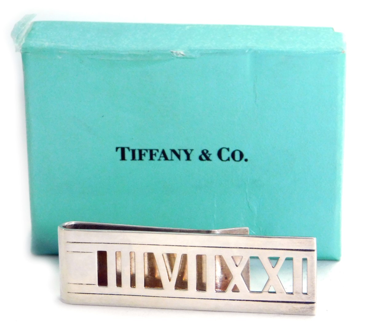 A Roman numeral money clip, stamped Atlas 2004 Tiffany and Co 925, 0.60oz, in Tiffany and Co turquoi
