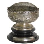 An Indonesian white metal bowl, with hammered safari scene body, on a stepped and ribbed foot, with