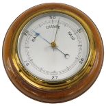 An aneroid barometer with silvered dial, in mahogany case, 18cm diameter.
