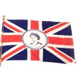 An Elizabeth II Union Jack material flag, the flag 74cm x 52cm, on pine pole 144cm long.