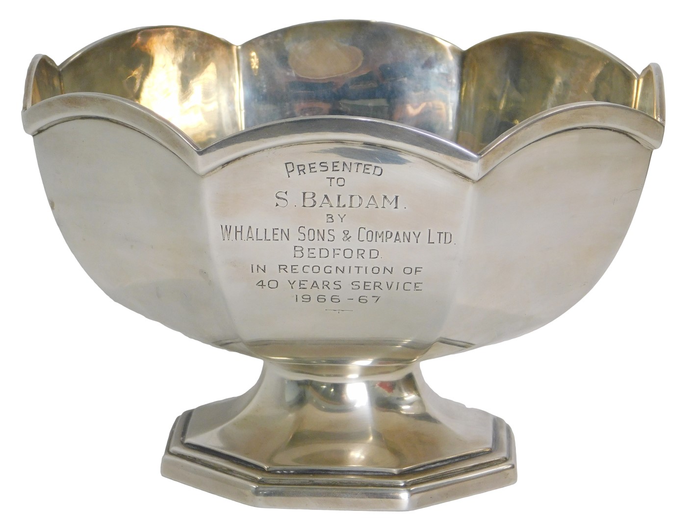 A Queen Elizabeth II silver presentation rose bowl, with eight sided arched border bearing inscripti