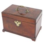 A George III mahogany tea caddy, the hinged top with a brass handle enclosing three divisions to the