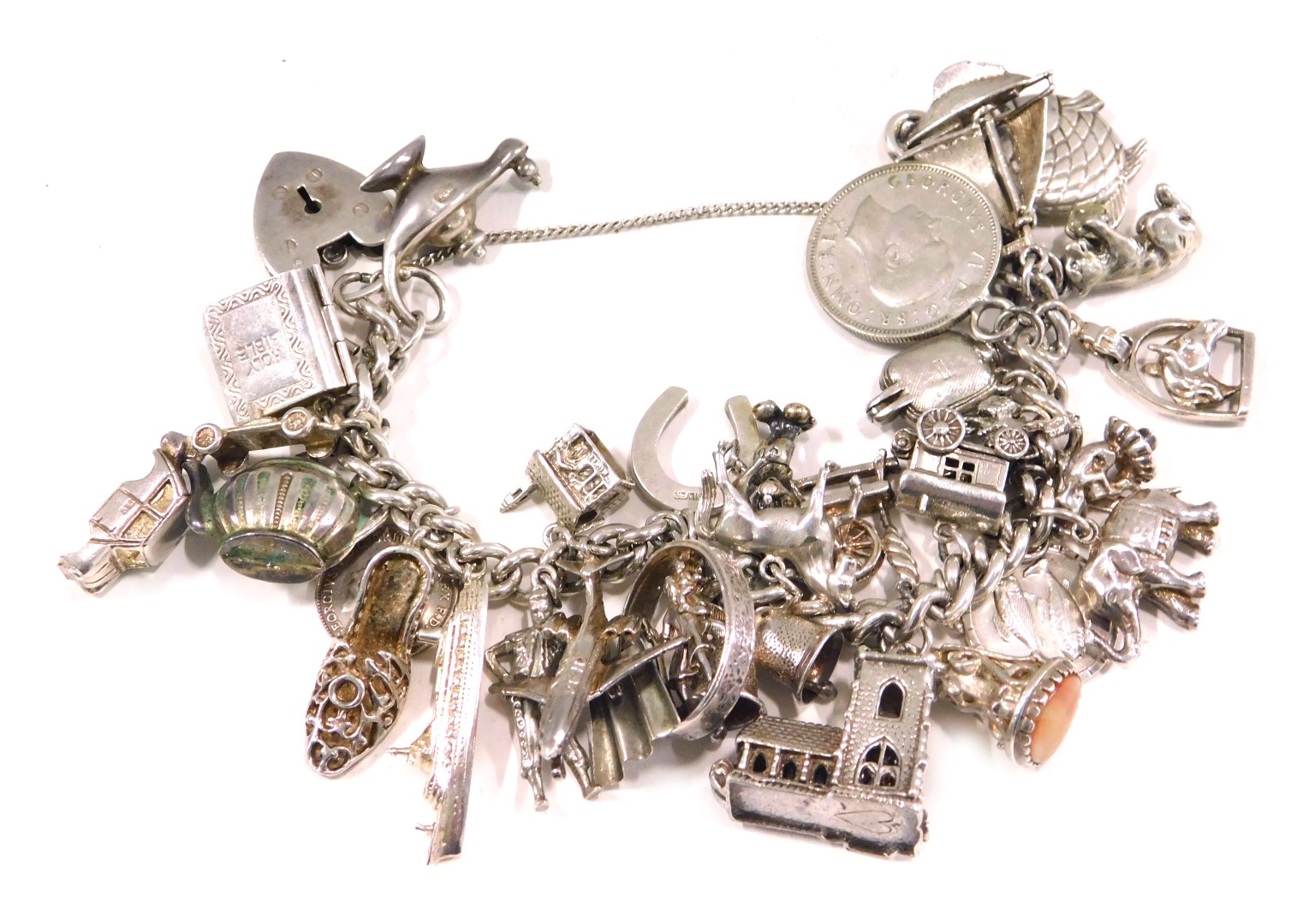 A silver charm bracelet, the curb link bracelet, with safety chain in heart shaped padlock, and vari