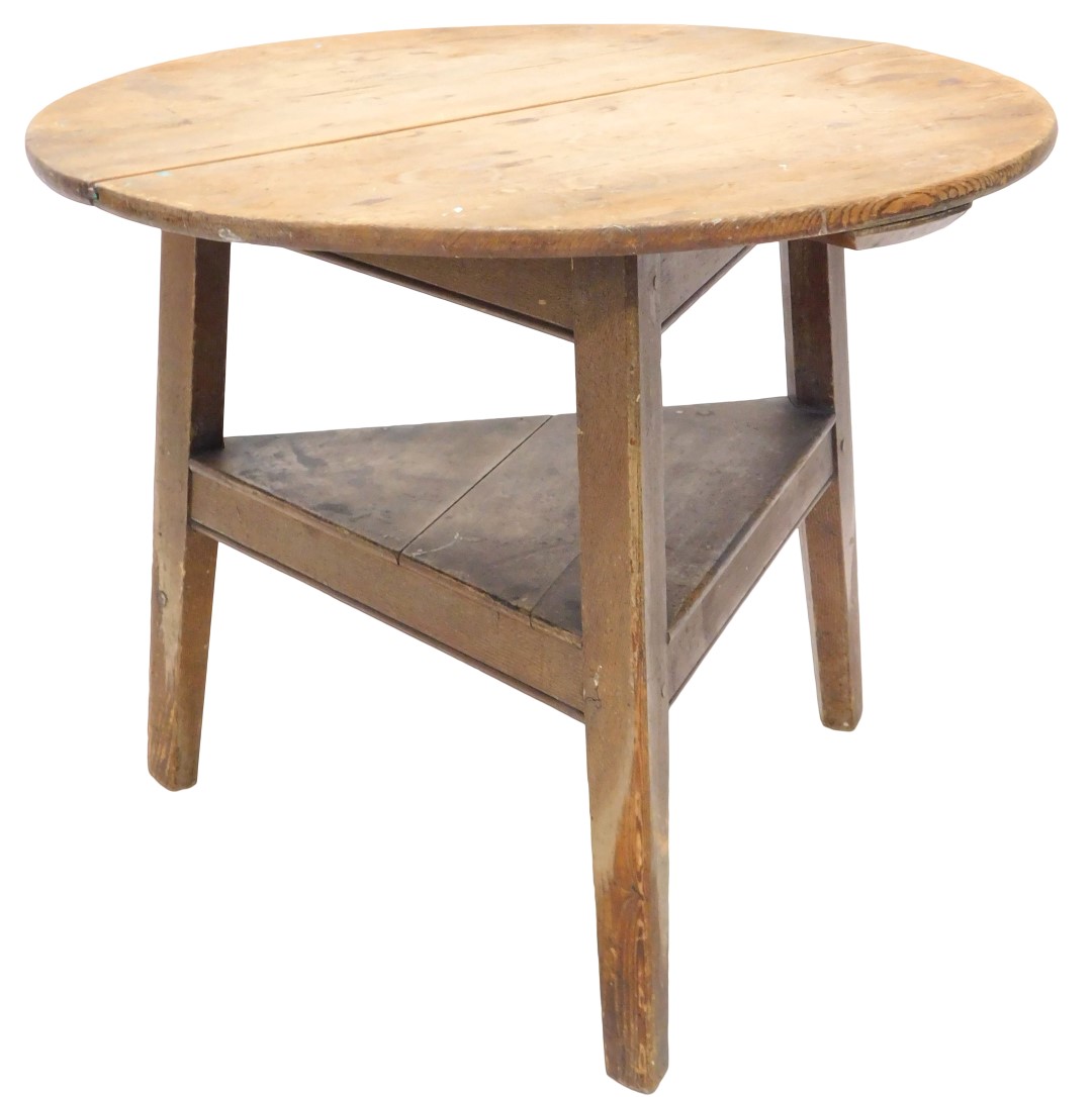 A 19thC pine cricket table, the two piece circular top on a triform scumbled base, with undertier (A