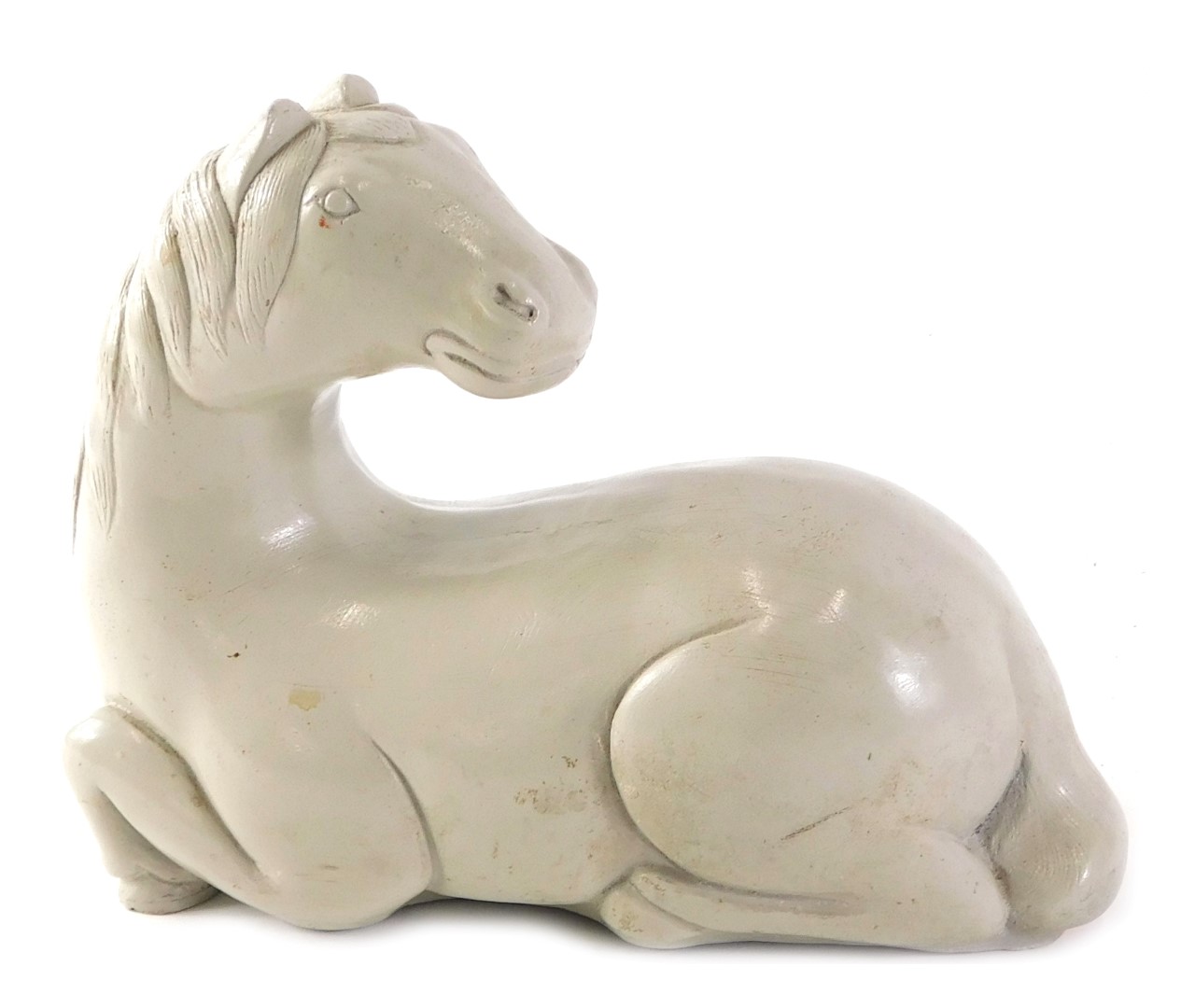 A composite figure of a Chinese horse, stamped A Proo 1961, in seated position, 18cm wide.