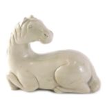 A composite figure of a Chinese horse, stamped A Proo 1961, in seated position, 18cm wide.