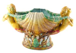 A 20thC majolica centrepiece, modelled in the form of two nude females either side of a clam shell,