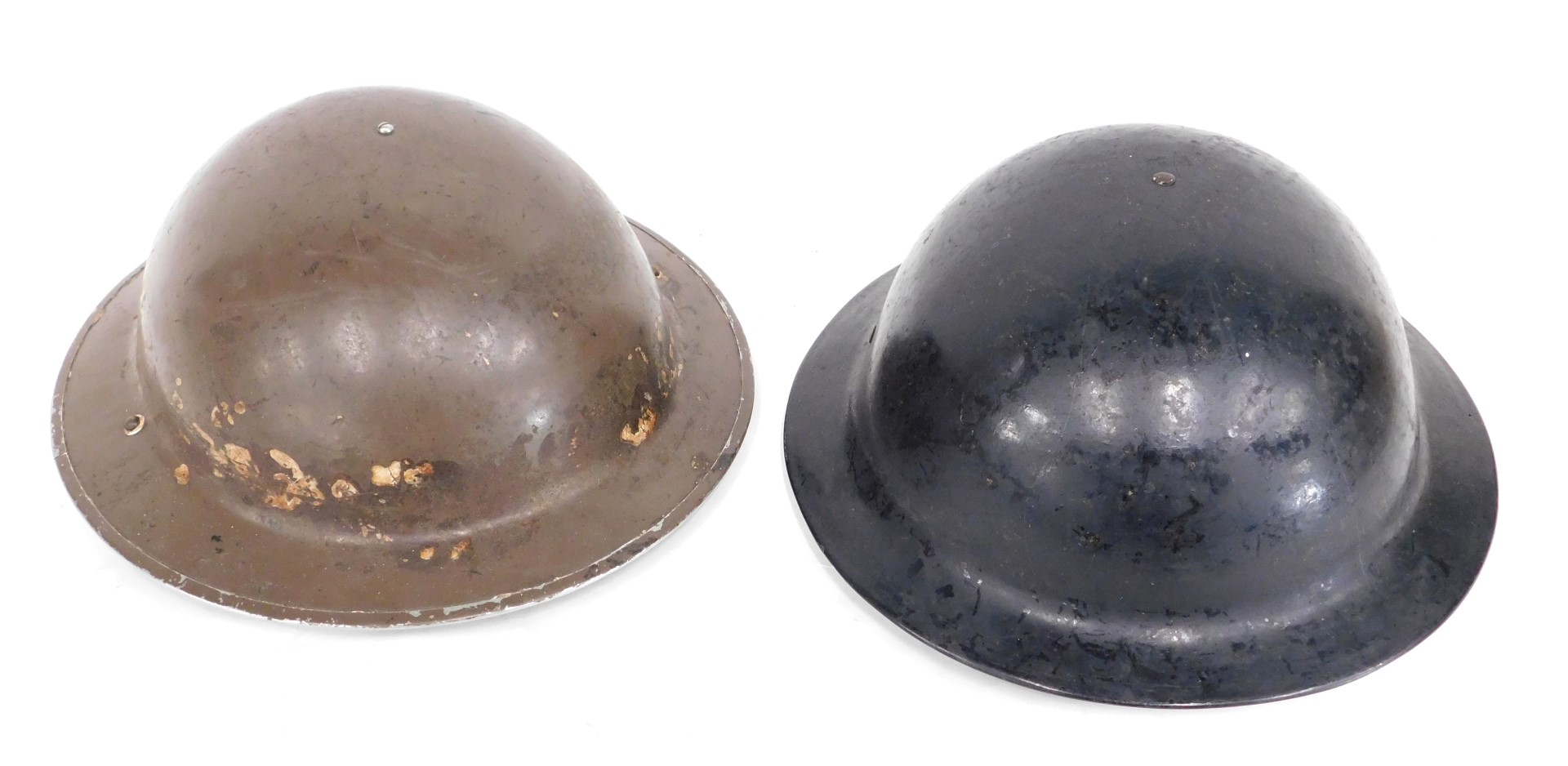 A Plasfort air warden helmet, stamped Sheffield, in black finish, 31cm wide, and another in brown fi