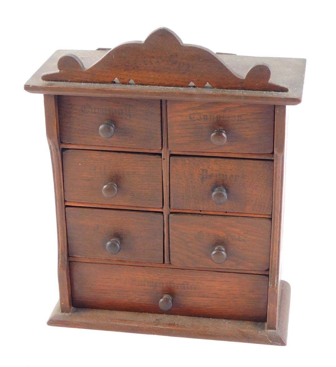 A late 19th/early 20thC oak spice cabinet, the drawers with indistinct stencil decoration and turned