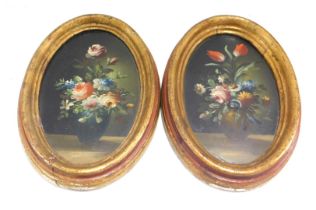 A pair of Italian 20thC miniature still life paintings of flowers, each of oval form, oil on board,