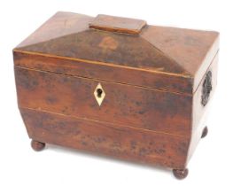 A Victorian yew sarcophagus shaped tea caddy, the hinged lid enclosing two lidded divisions, lacking