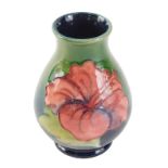 A Moorcroft freesia pattern miniature vase, 11cm high.