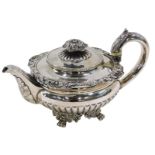 A Victorian silver teapot, with leaf moulded thumb piece, on a reeded handle, with shall capped and