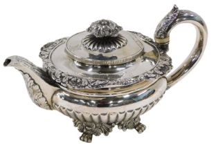 A Victorian silver teapot, with leaf moulded thumb piece, on a reeded handle, with shall capped and