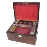 A Victorian rosewood dressing case, the hinged lid with vacant oval cartouche containing various gla