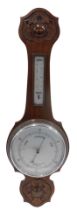 An Edwardian mahogany aneroid wheel shaped barometer with thermometer, in a carved case, 82cm high.