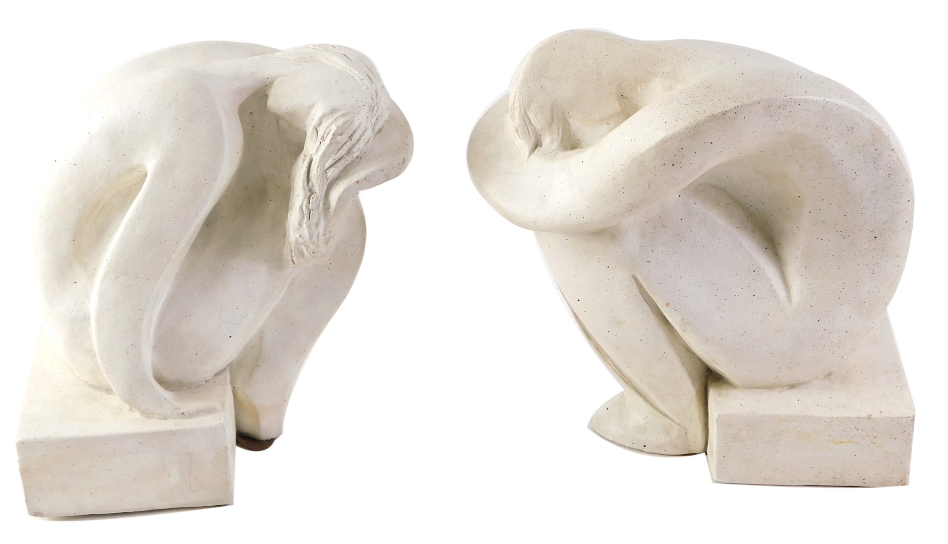 A pair of composite cast Youth book ends, each formed as a person arched over plinth, 20cm high.