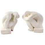 A pair of composite cast Youth book ends, each formed as a person arched over plinth, 20cm high.