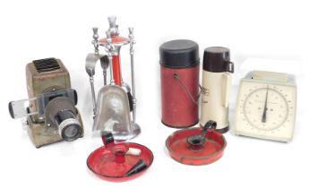 1950s and later wares, comprising Aldis projector, two red enamel candle stands, a fireside trivet,