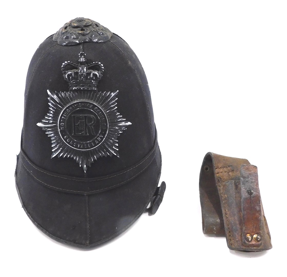 A Nottinghamshire County police helmet, together with a leather bayonet frog.