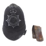 A Nottinghamshire County police helmet, together with a leather bayonet frog.