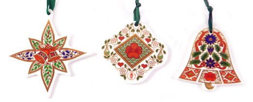 Three Royal Crown Derby Christmas decorations, comprising bauble, star, and bell, 7cm high, on ribbo