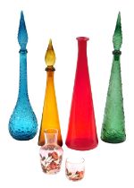 Four coloured glass pharmacist's type bottles, one lacking stopper, and a water jug with beaker.